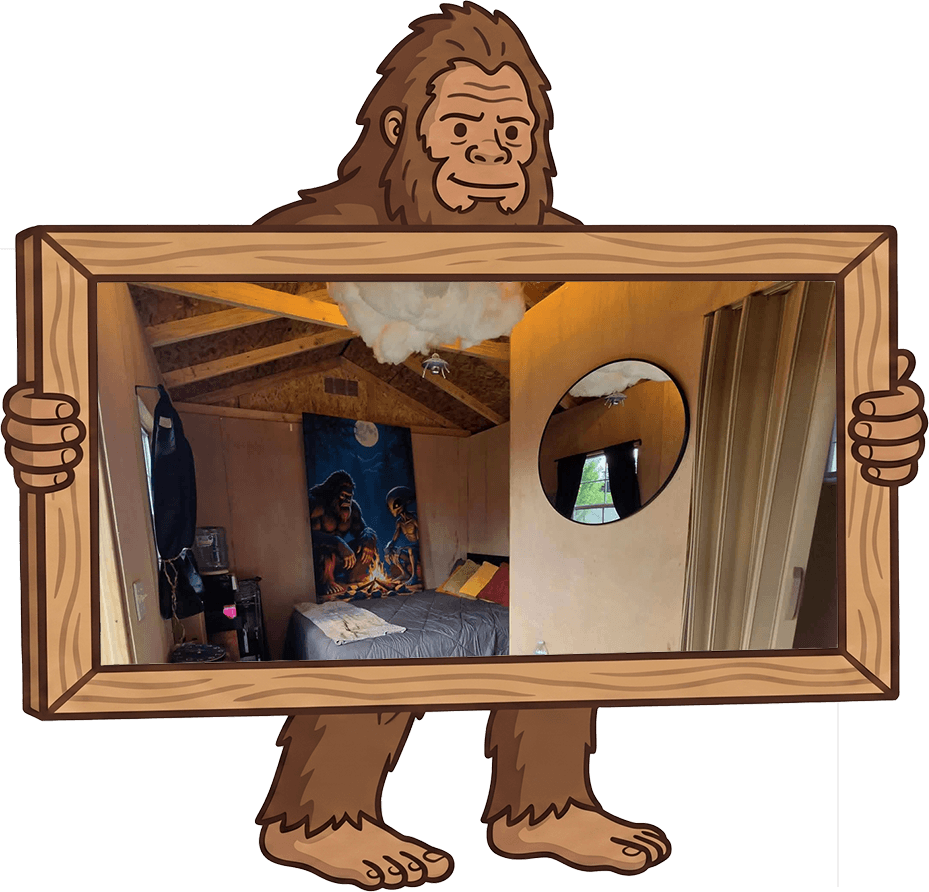 Bigfoot cabin character holding a framed photo